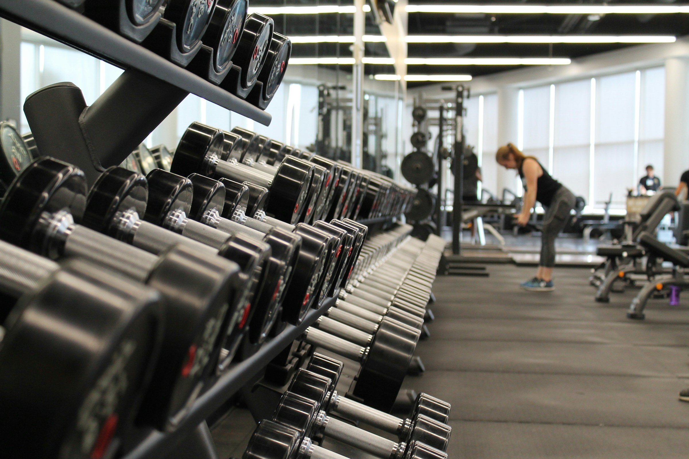 Weight training floor with dumbbells, benches, and strength equipment